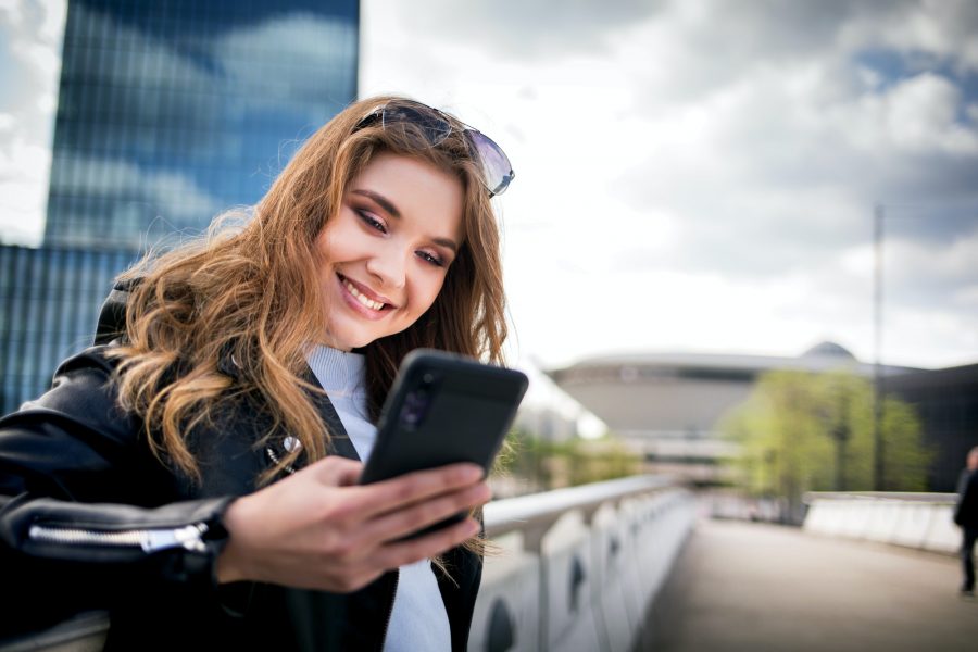 Young woman using smarthphone in modern city
